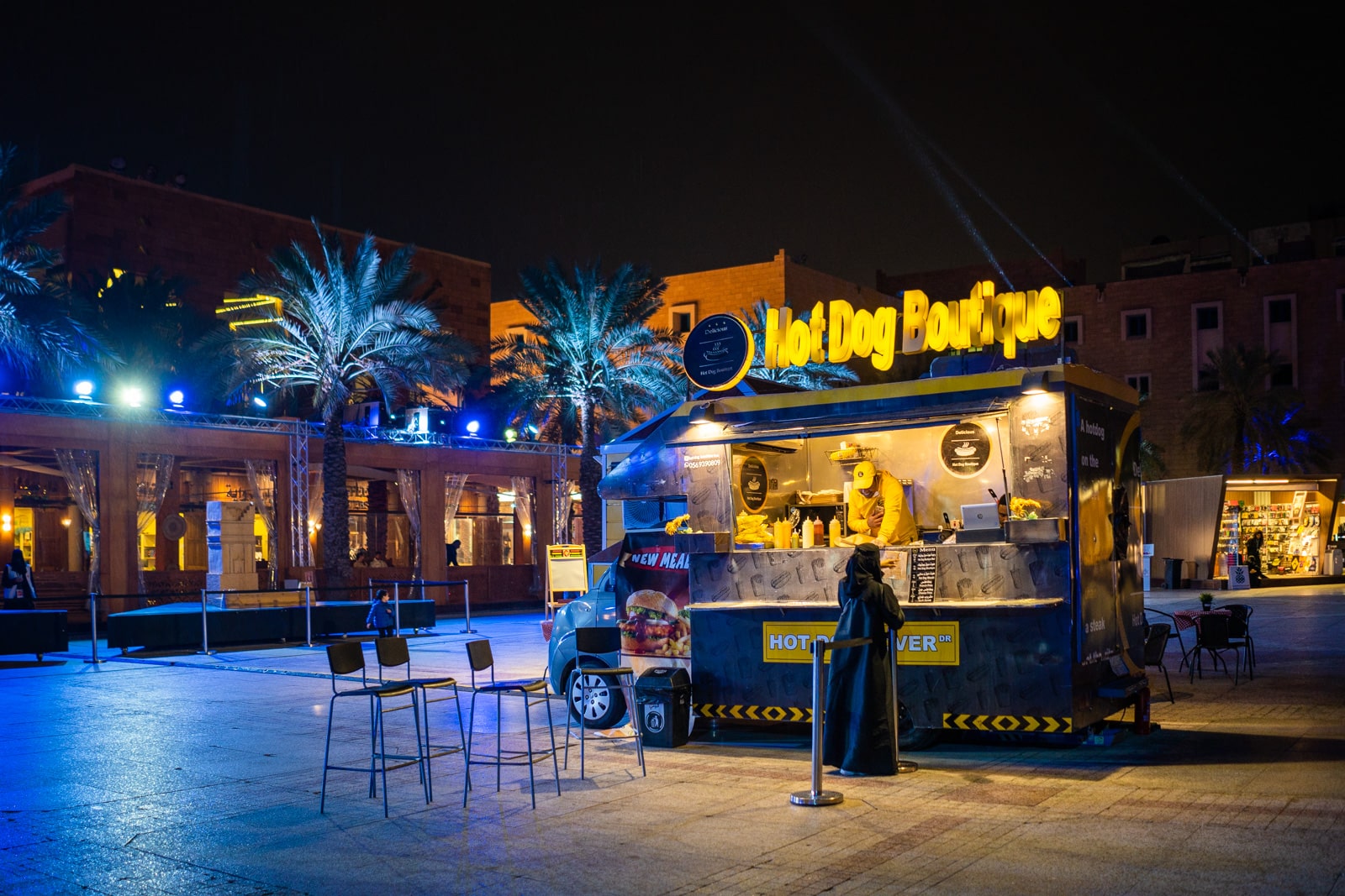 Woman at a hot dog stand during Riyadh Season in Saudi Arabia