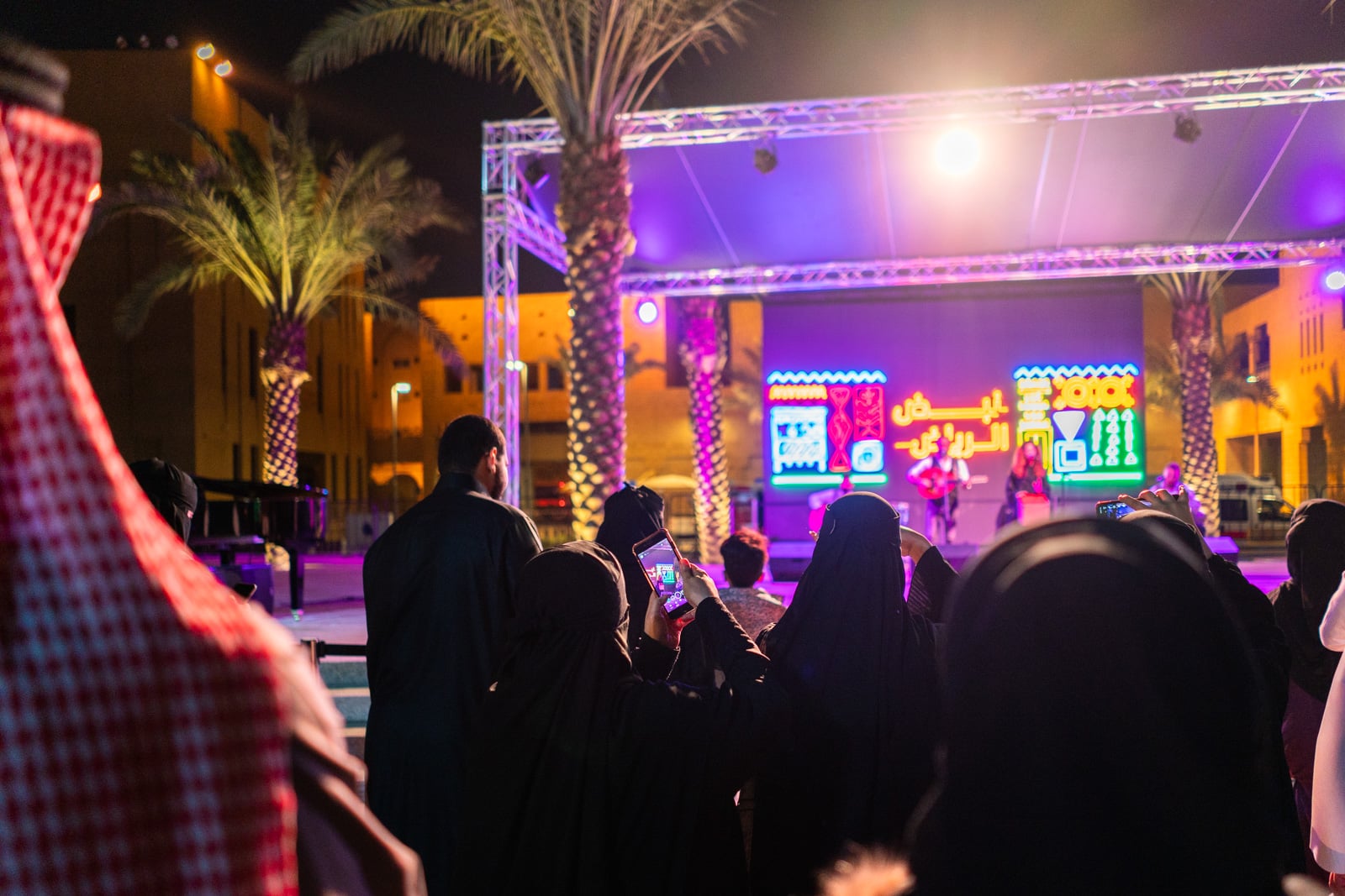 Women filming a concert on their mobiles in Riyadh, Saudi Arabia