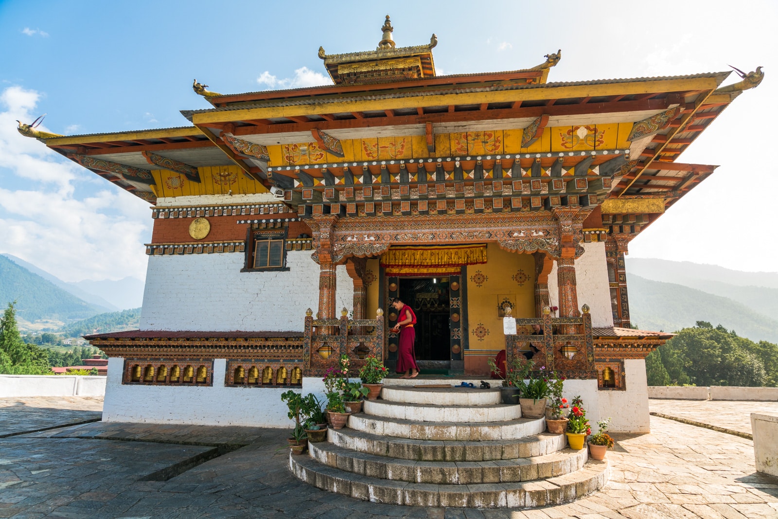 Monk standing on the doorway of a small monastery in Punakha