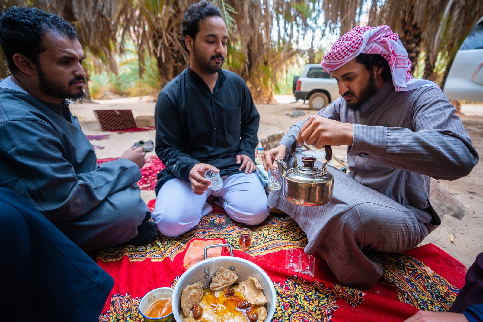 Group of men camping and making tea in Wadi Disah, Saudi Arabia