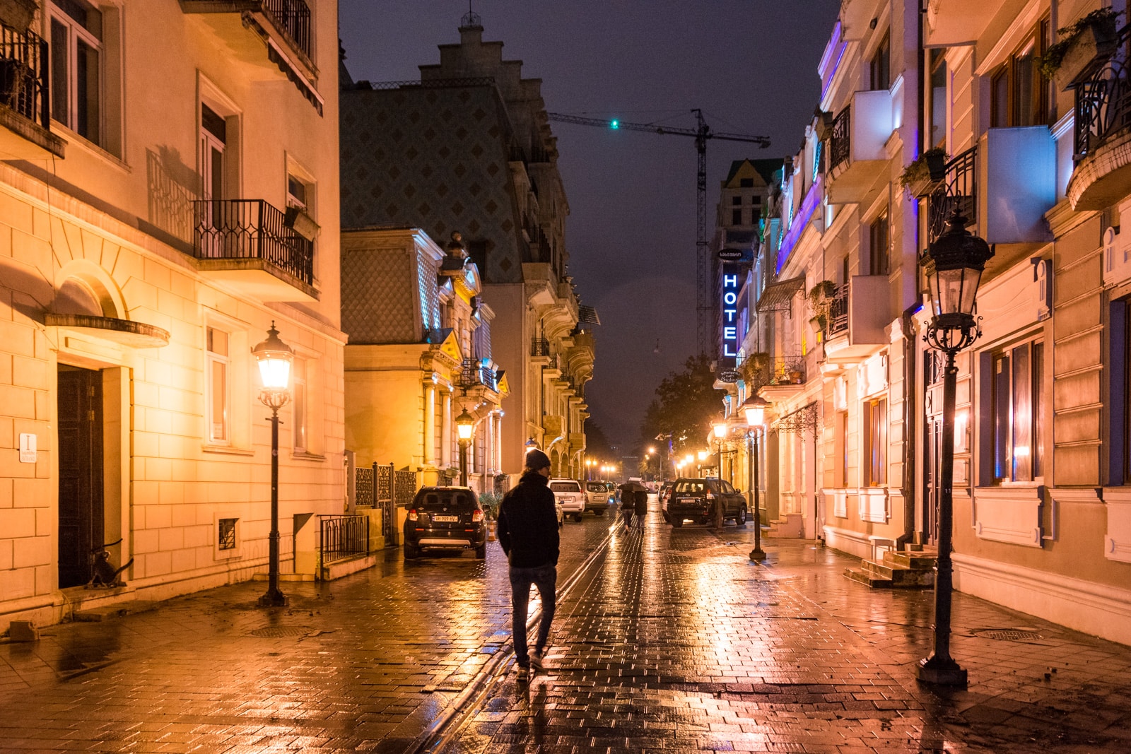 Man walking on the street at night in Batumi, Georgia