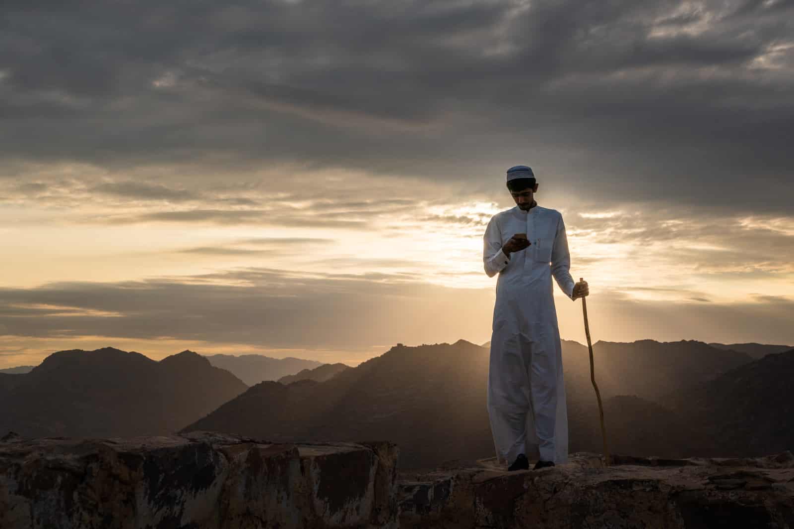 Saudi boy using his mobile phone in Najran, Saudi Arabia