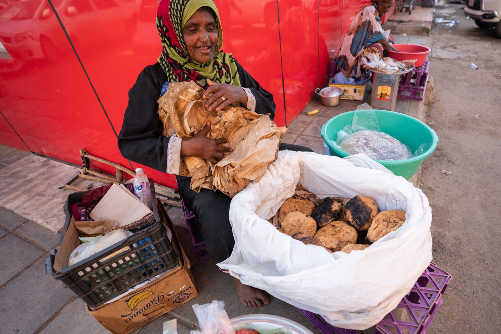 Yemeni woman selling bread and chutney on the streets of Jazan, Saudi Arabia