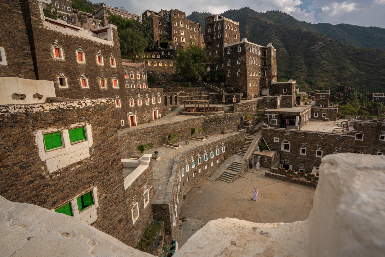 Saudi man standing in Rijal Alma heritage village, Saudi Arabia