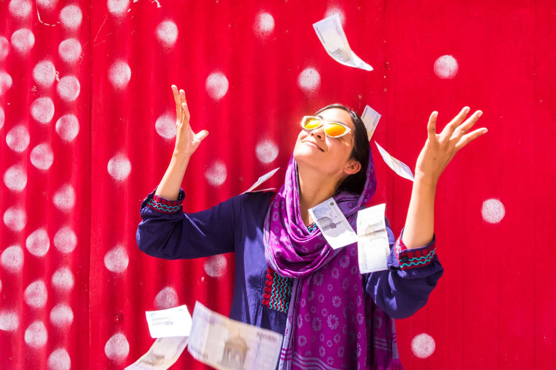 Rich female traveler tossing money in Iran