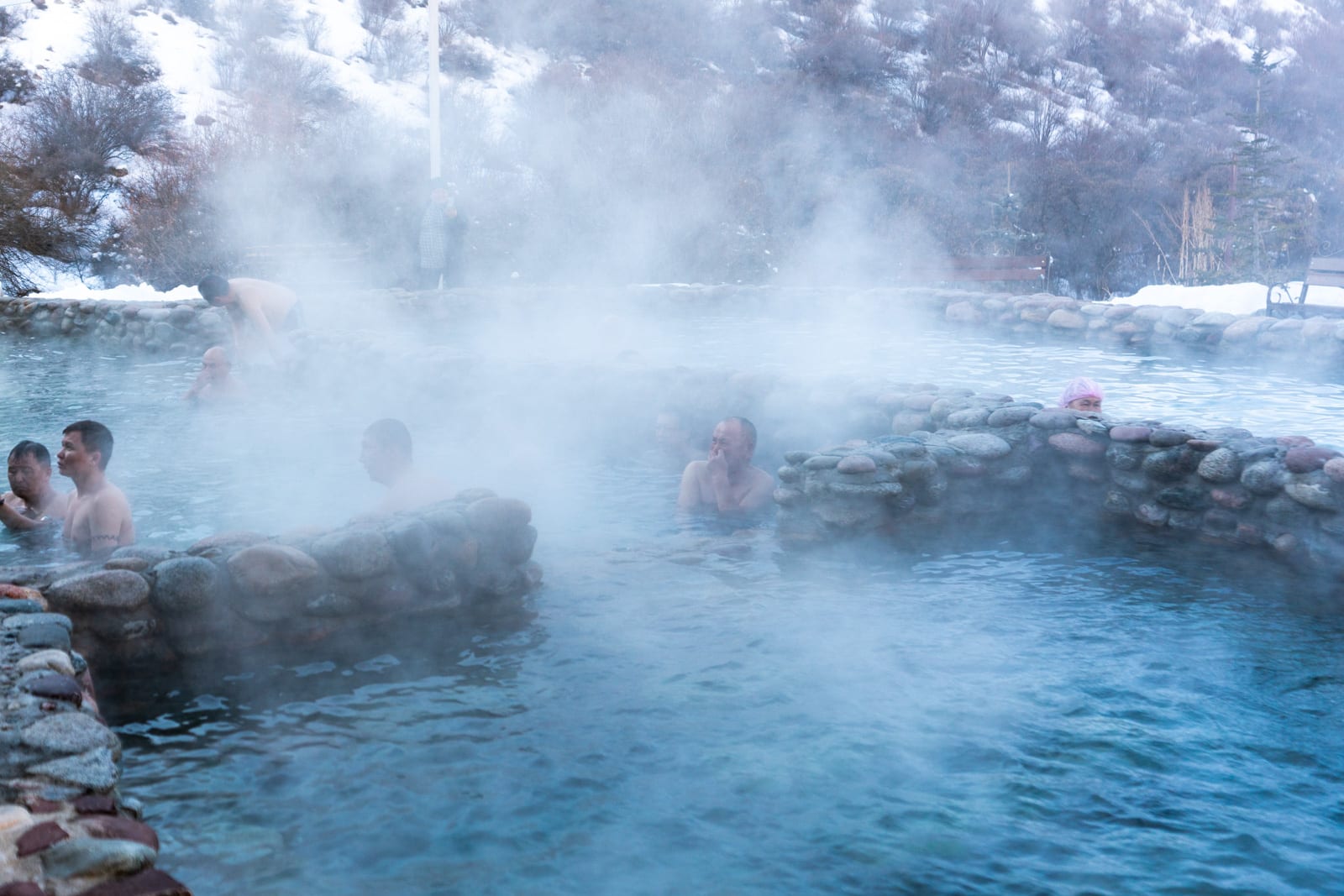 Locals in Ak Suu Kench hot springs in Kyrgyzstan in winter