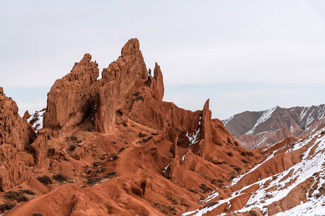 Hiker in Fairytale canyon, Kyrgyzstan with snow