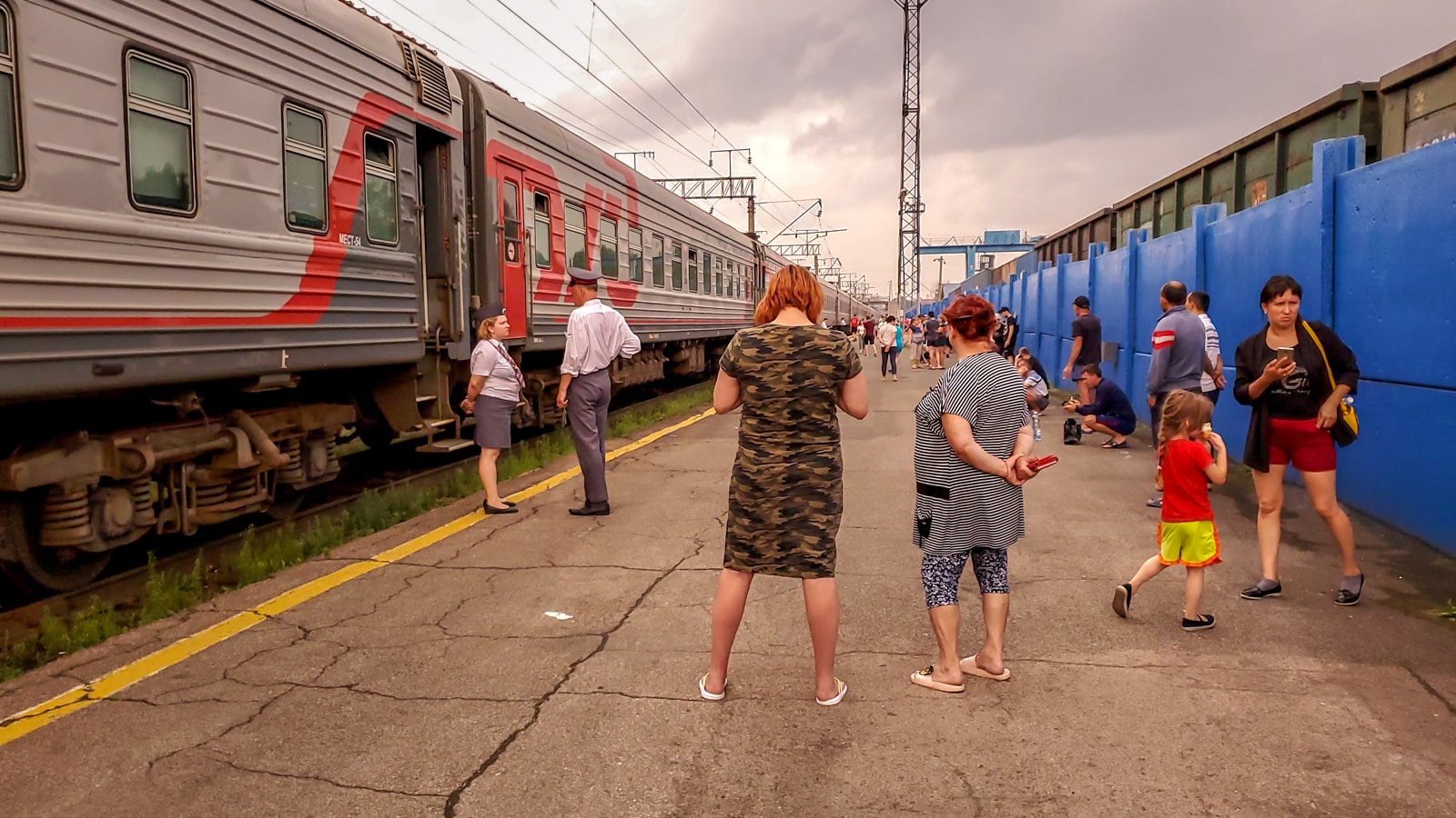 Train passengers standing at Marinsk train station, Russia