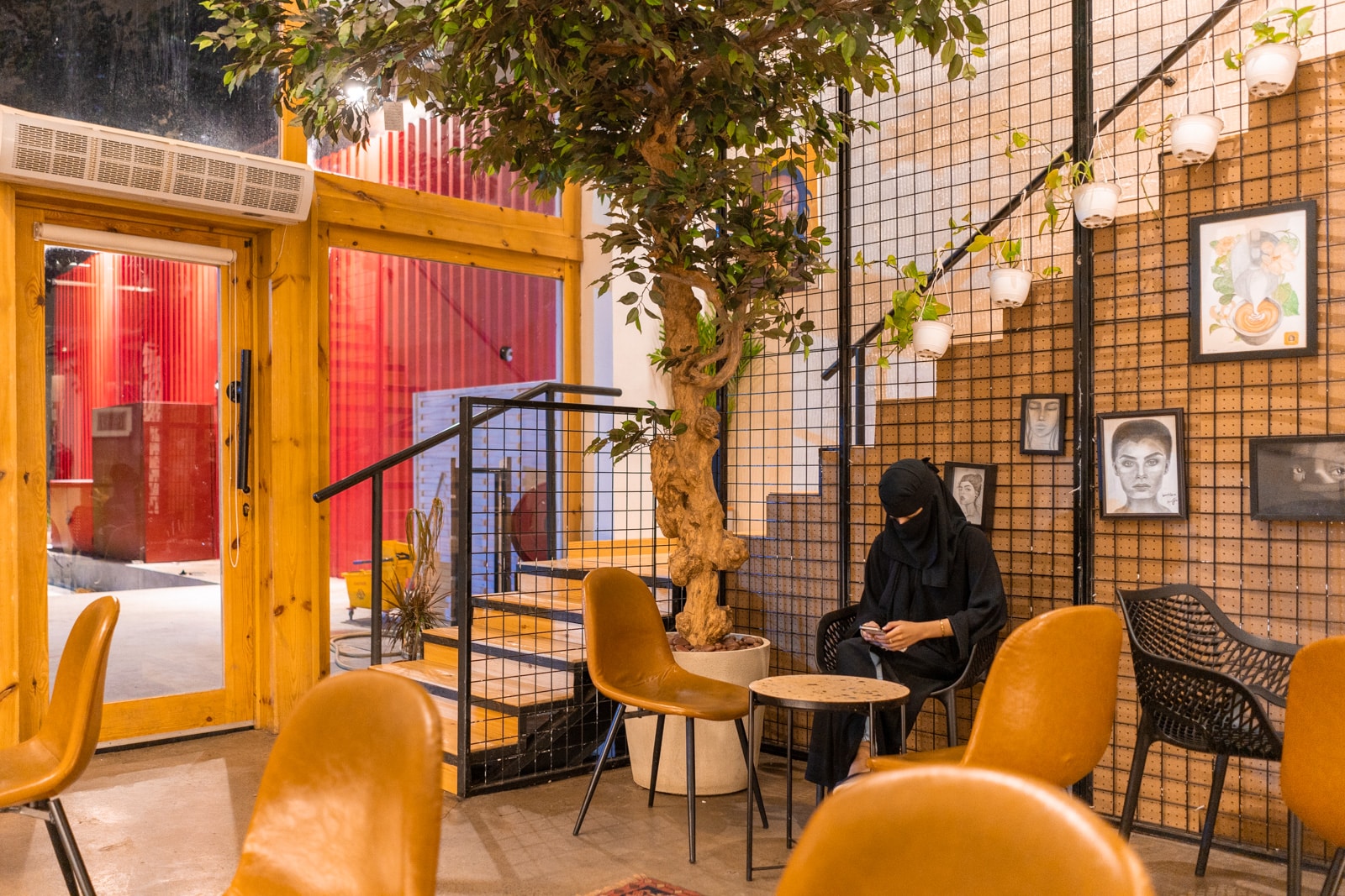 Woman sitting in a coffee shop in Jazan, Saudi Arabia