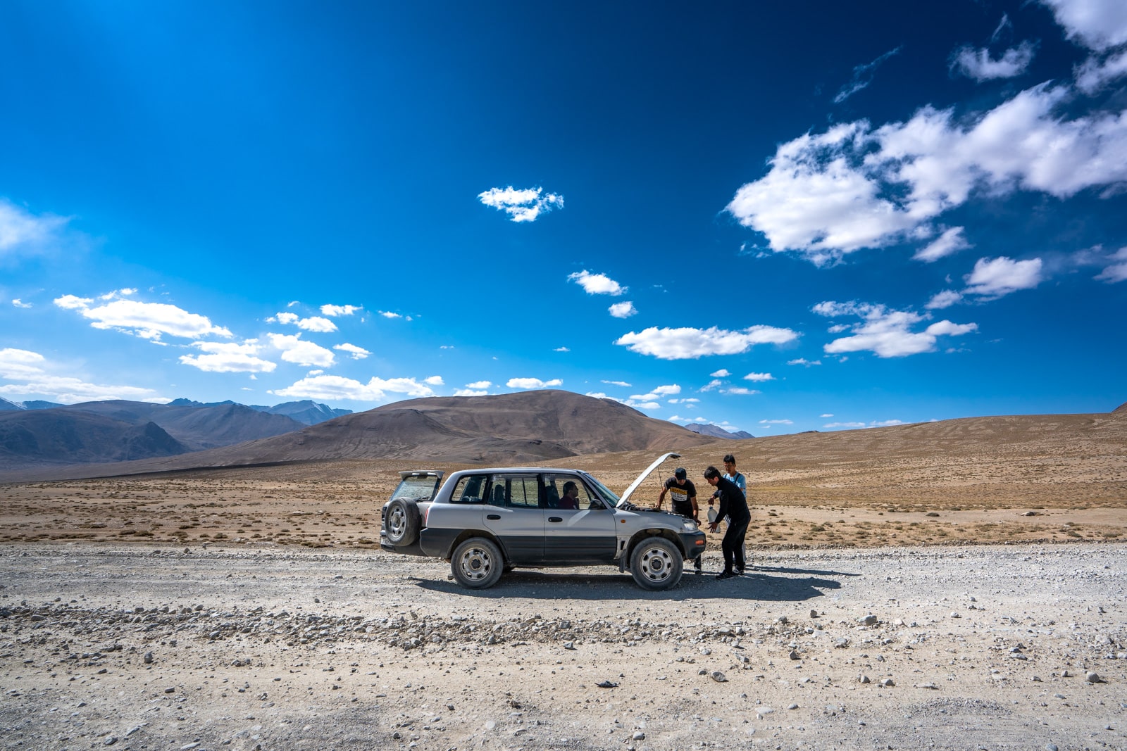 Shared taxi breaking down on Pamir Highway in Tajikistan