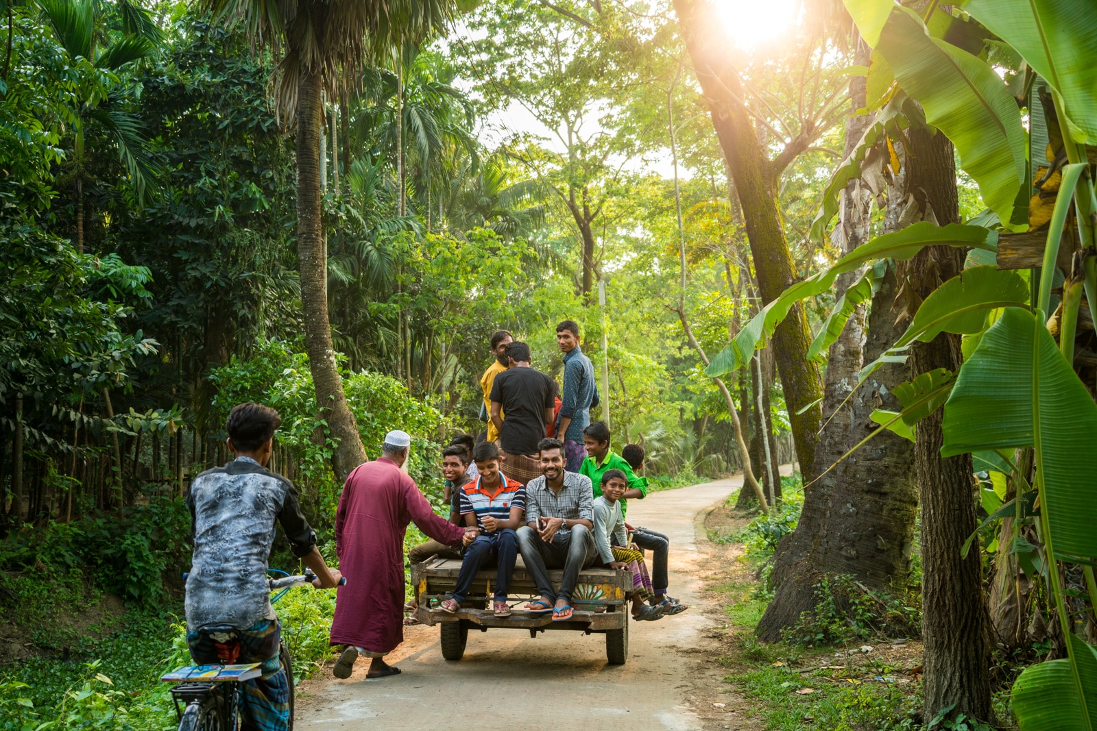 Men and boys riding a van in Monpura island, Bangladesh