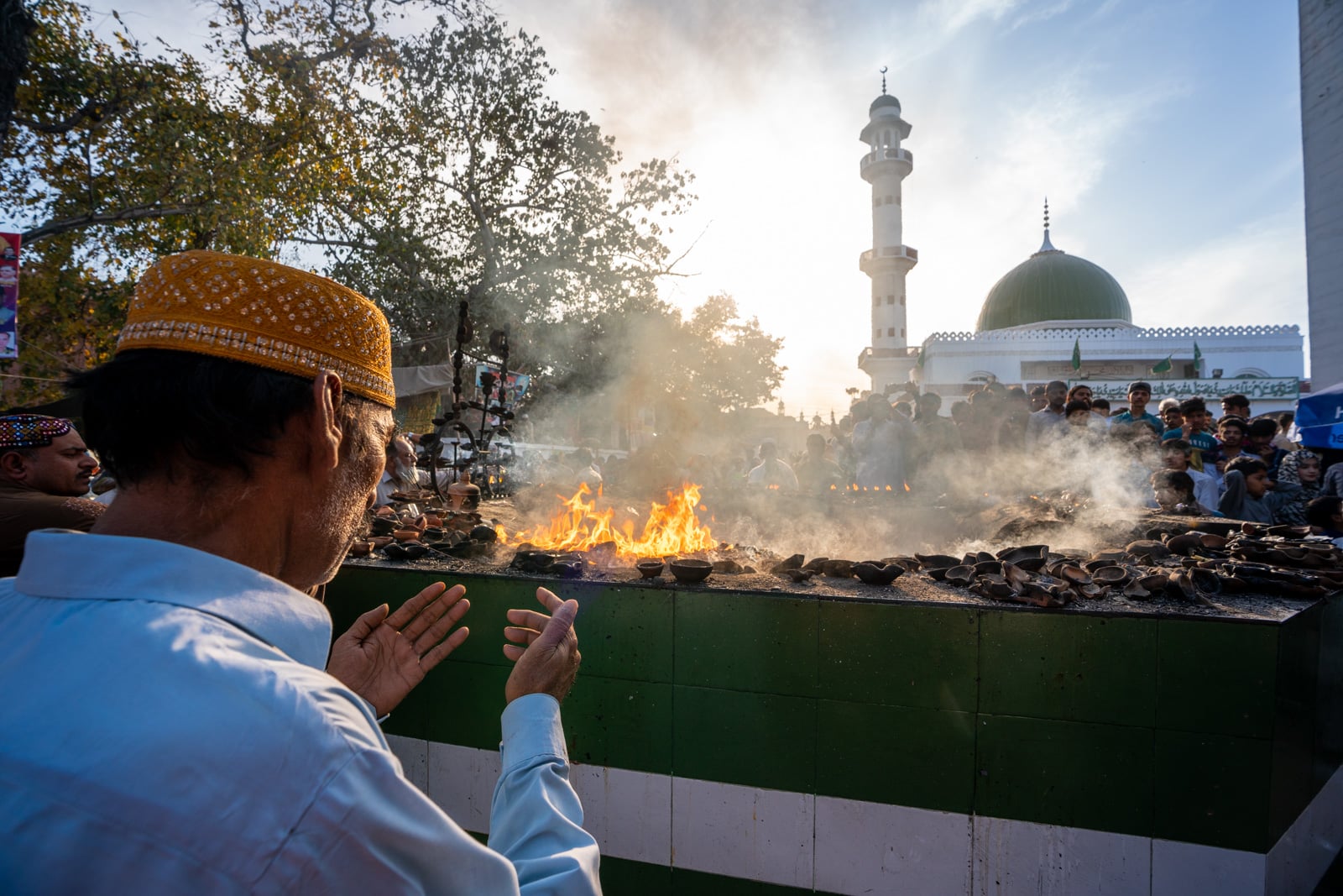 Man praying at a sufi shrine in Lahore, Pakistan