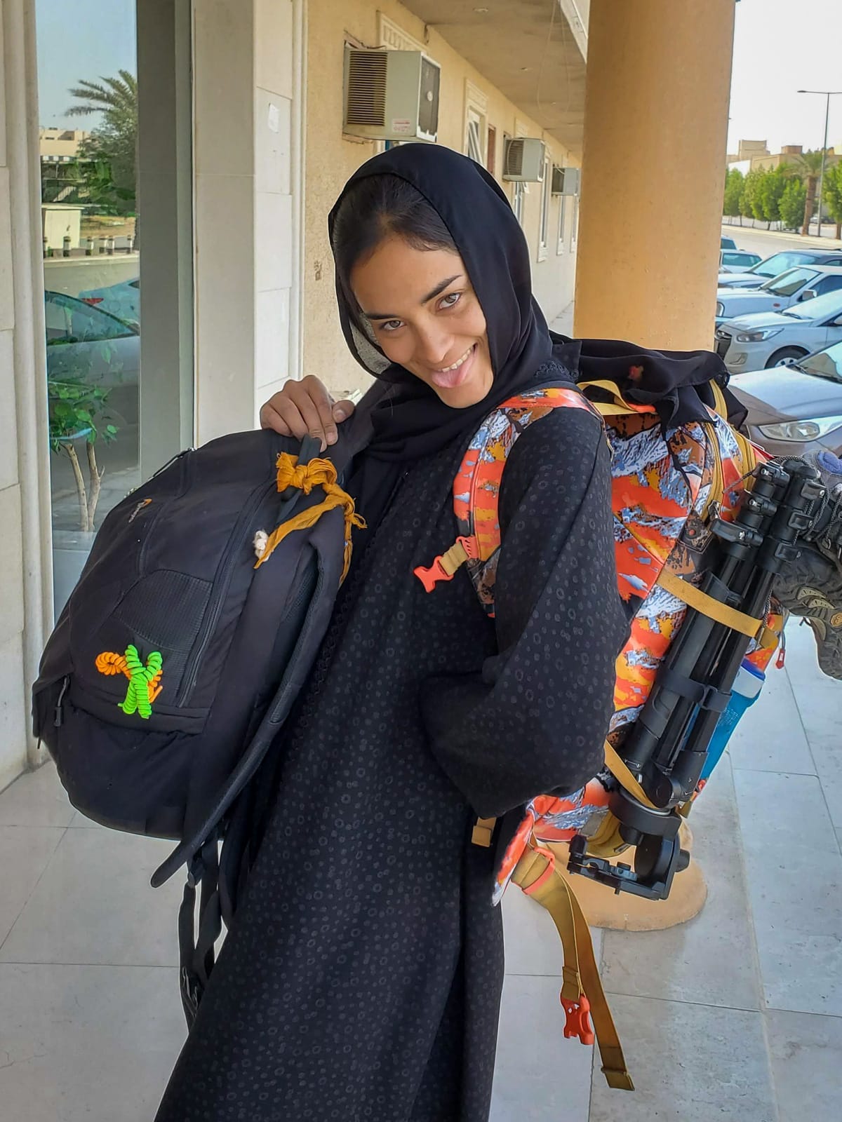 Alex with camera bag and backpack in a black abaya in Riyadh, Saudi Arabia