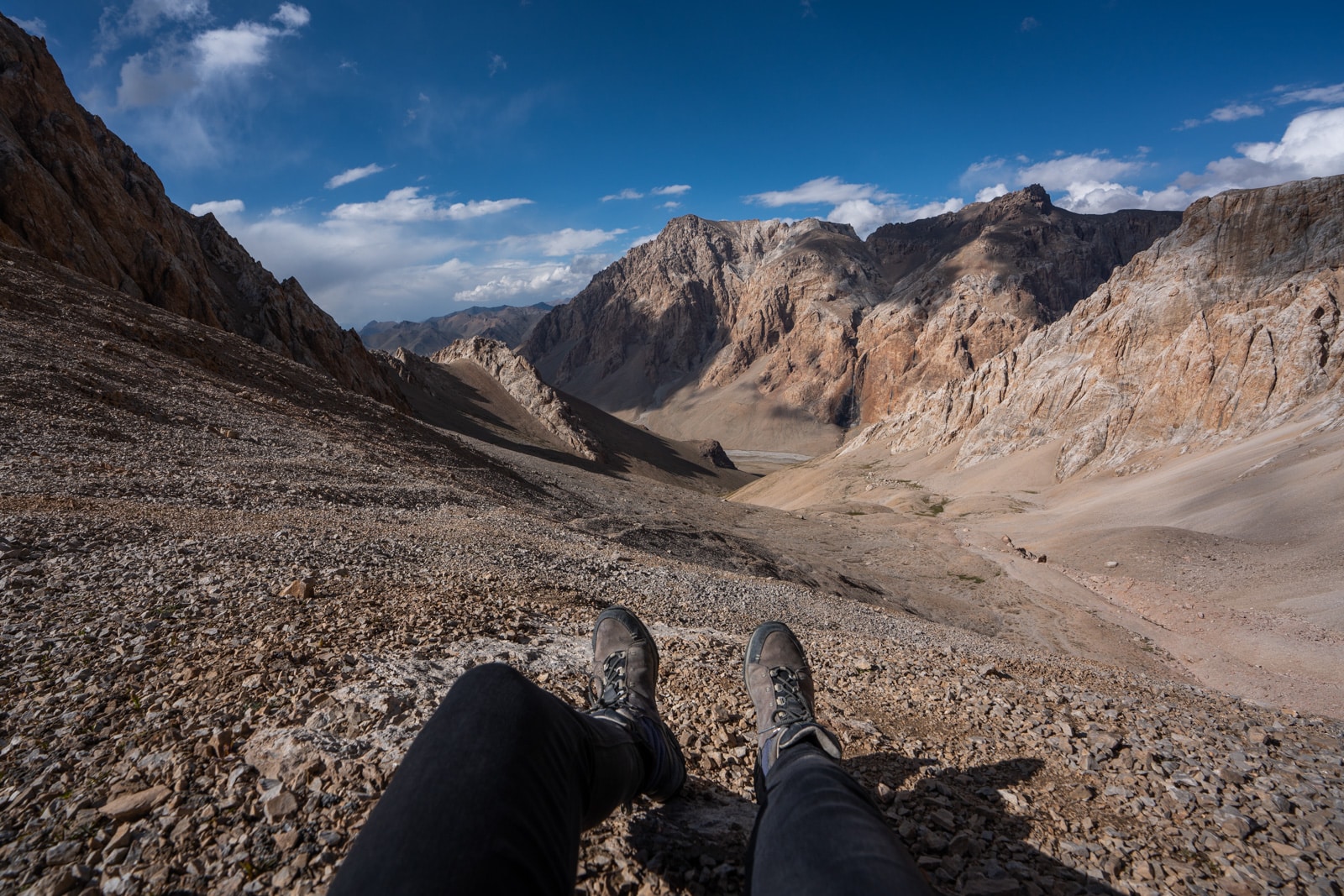 Taking a break on a mountain pass while trekking in the Pamir Mountains around Shaimak