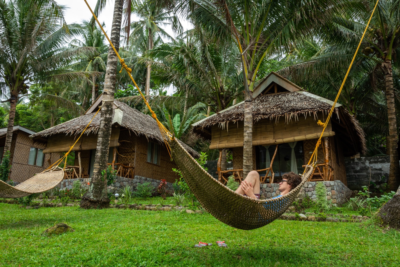 Boy relaxing in a hammock at Volcan Eco Resort on Camiguin Island, Philippines