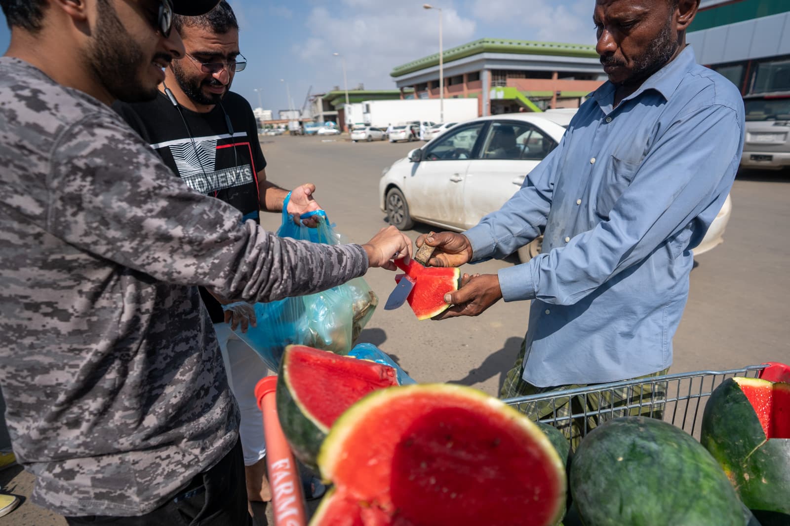 Male Couchsurfers tasting watermelon in Jazan, Saudi Arabia