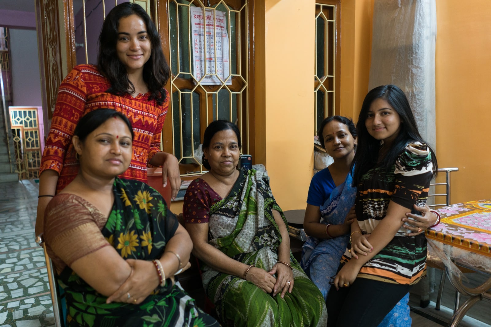 Alex with a family of women in a home in Kolkata, India