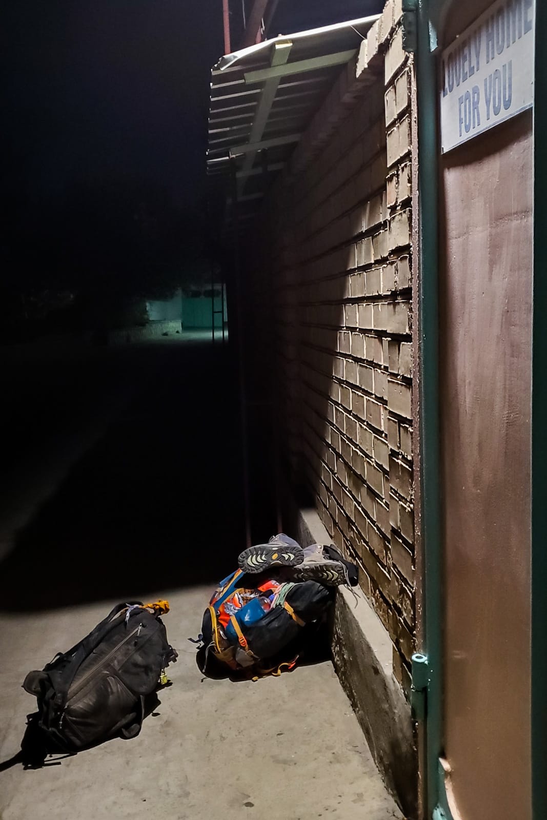 Backpacks outside a guesthouse in Osh, Kyrgyzstan at night