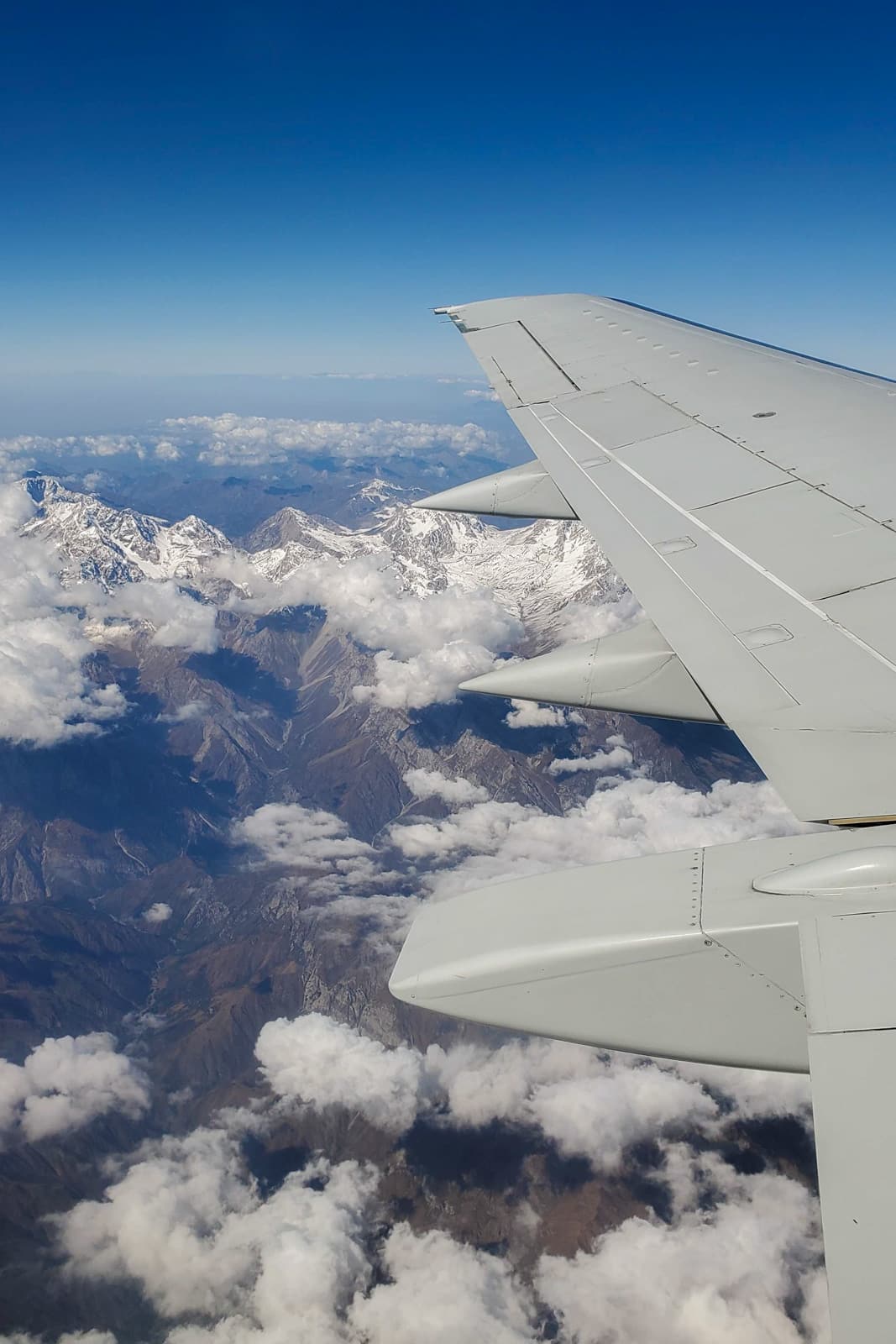 Plane wing over mountains in Kyrgyzstan