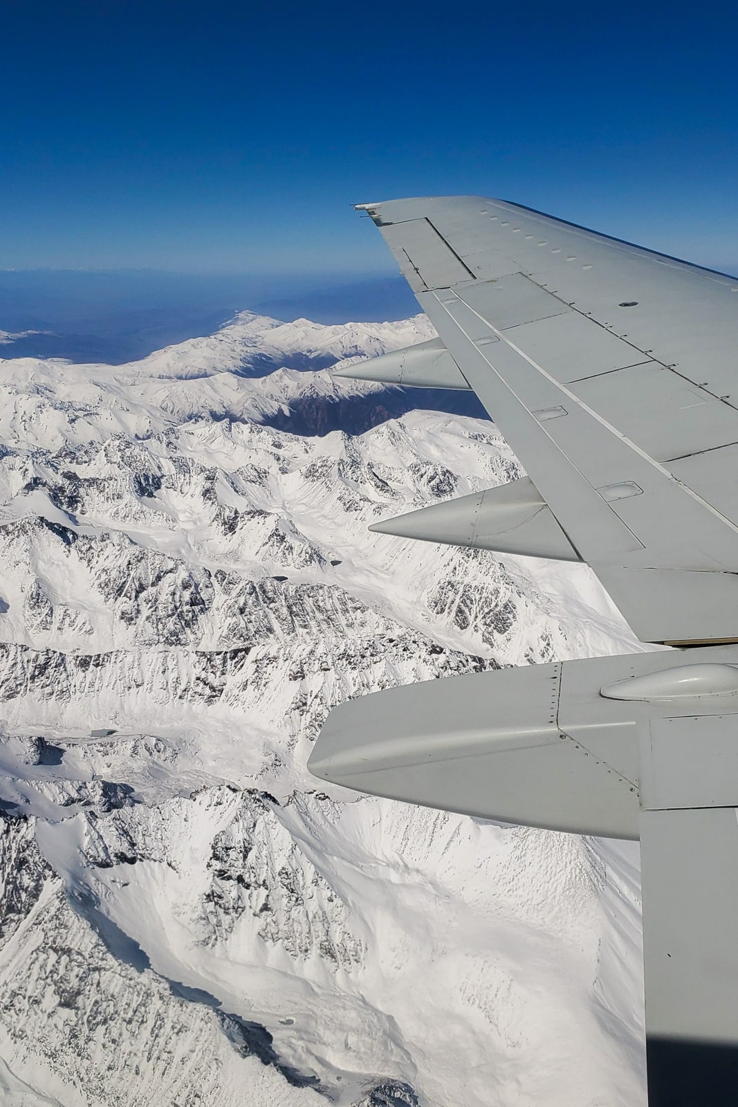 Plane wing over mountains in Kyrgyzstan