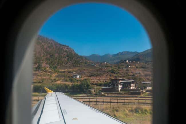 View of mountains in Bhutan through a plane window