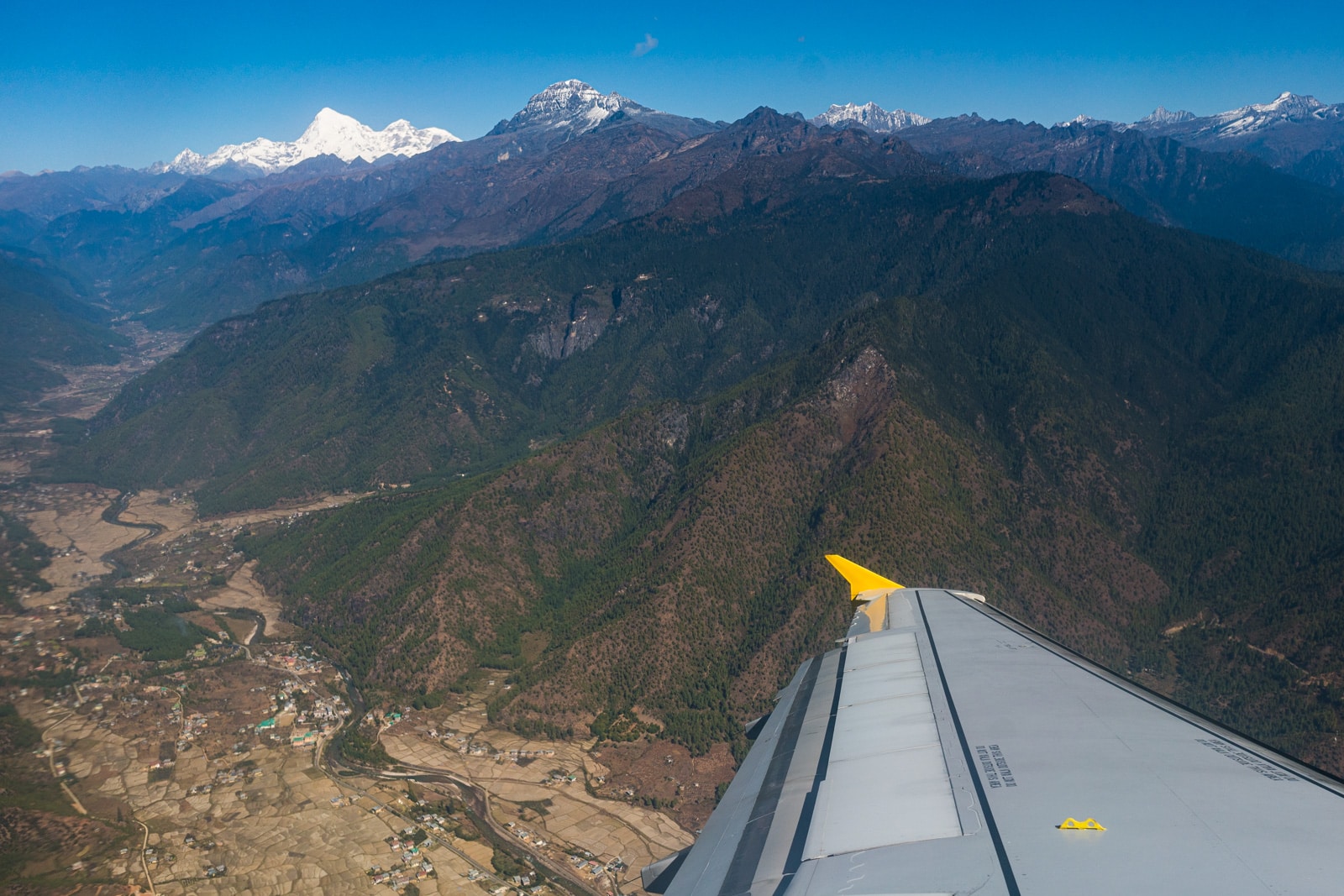 Plane wing flying over Bhutan