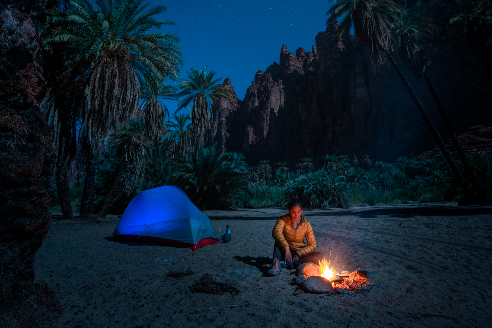 Alex at a campfire while camping in Saudi Arabia
