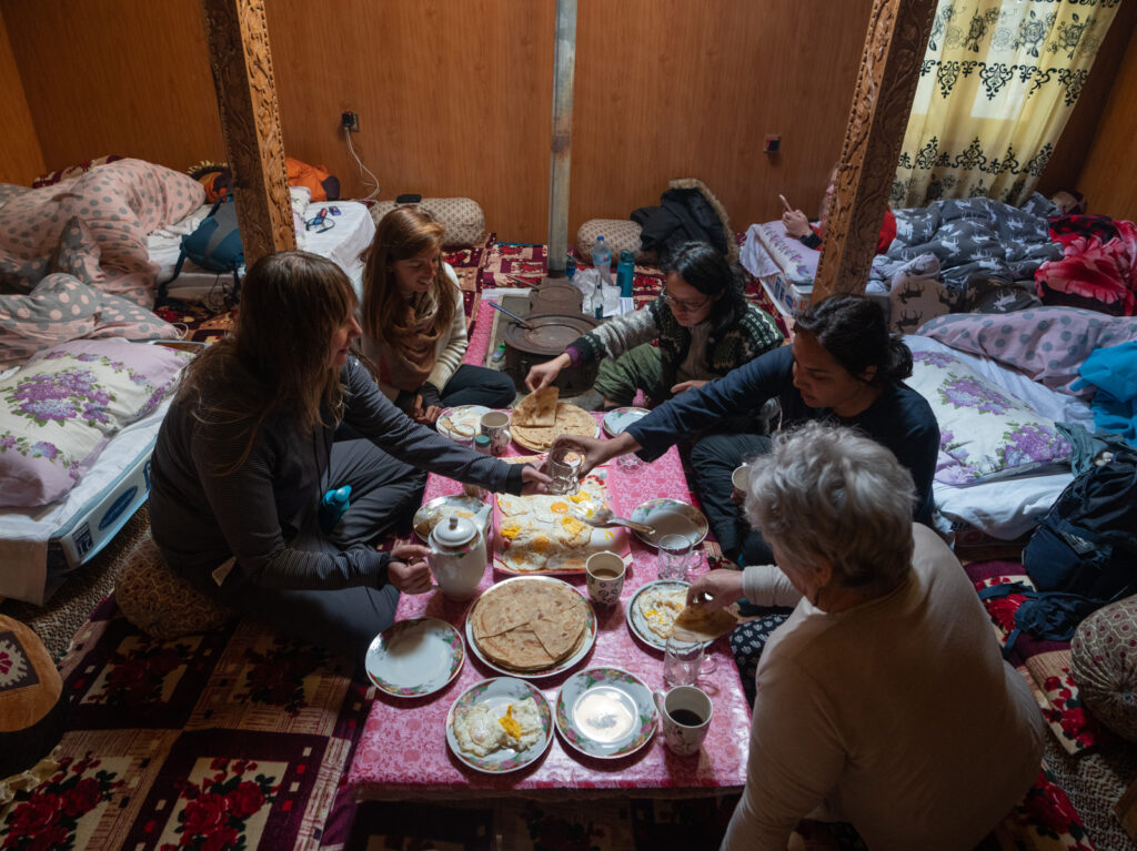 Women on a 2-week women's tour of Pakistan in the traditional hall of a Hunza homestay