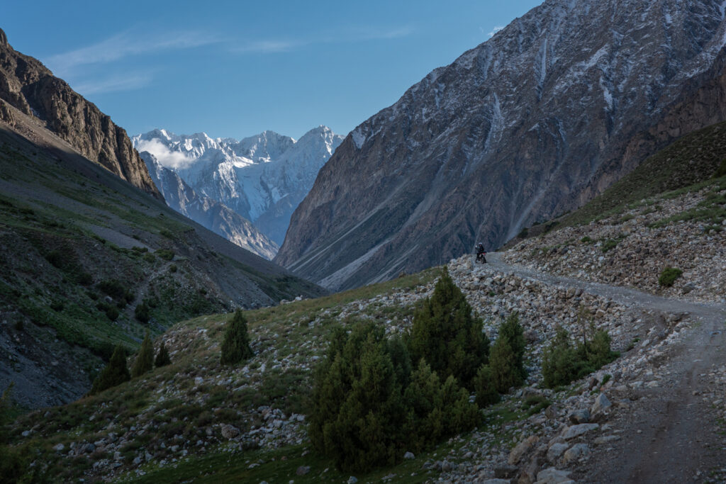 Biker traveling by motorcycle in Pakistan, riding on the road to Golen Gol park