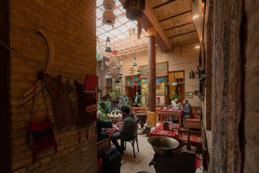 People having breakfast in the interior of the Al Hasun museum in Basra, Iraq.