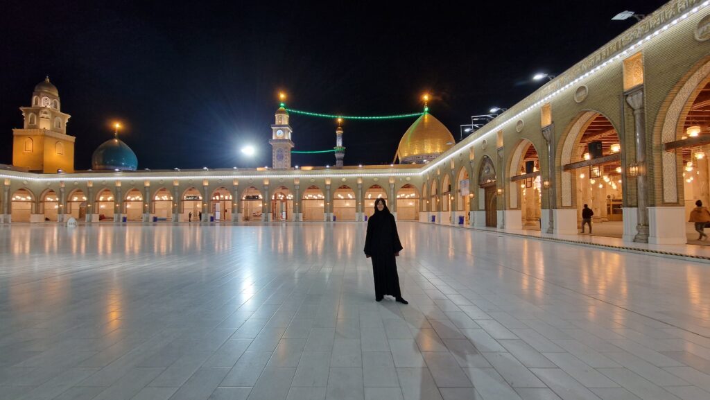 Solo female traveler in abaya at the Grand Mosque of Kufa in Iraq