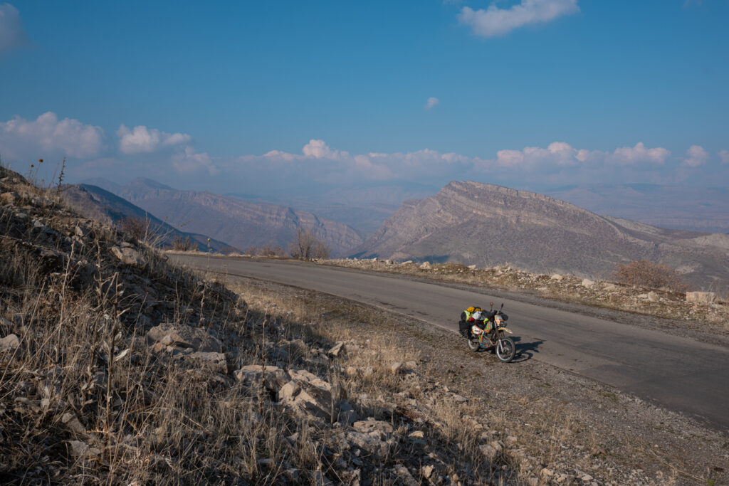 Motorcycle travel in Iraqi Kurdistan with mountains behind the road
