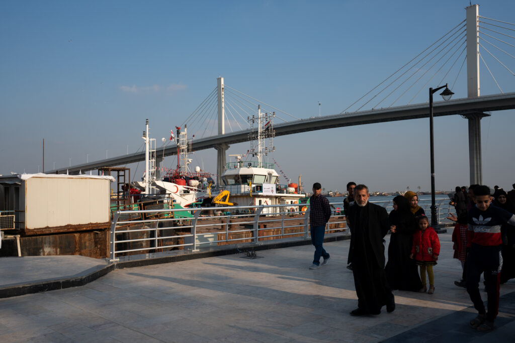 People walking on the riverside Corniche in Basra, Iraq