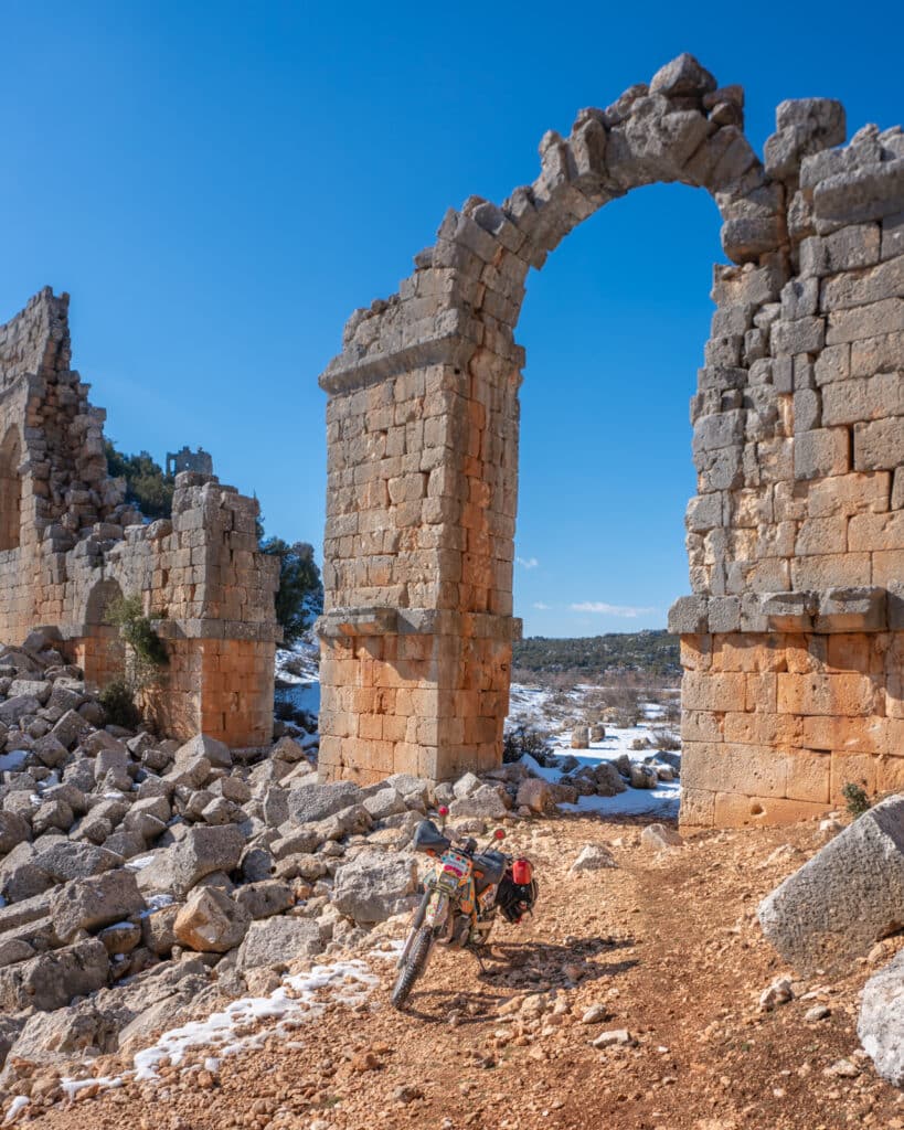 Motorcycle travel in Turkey: parked in the snow amidst Roman ruins near Mersin