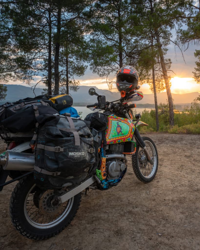 DR650 motorcycle during sunset on a lakeside in Turkey