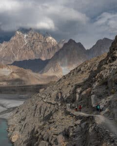 Guests walking to the Passu suspension bridge on a Pakistan 4x4 adventure tour.