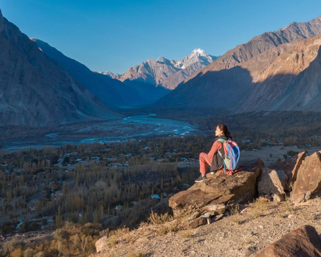 Drone shot of Alex sitting on a rock overlooking Chatorkhand, Ishkoman Valley