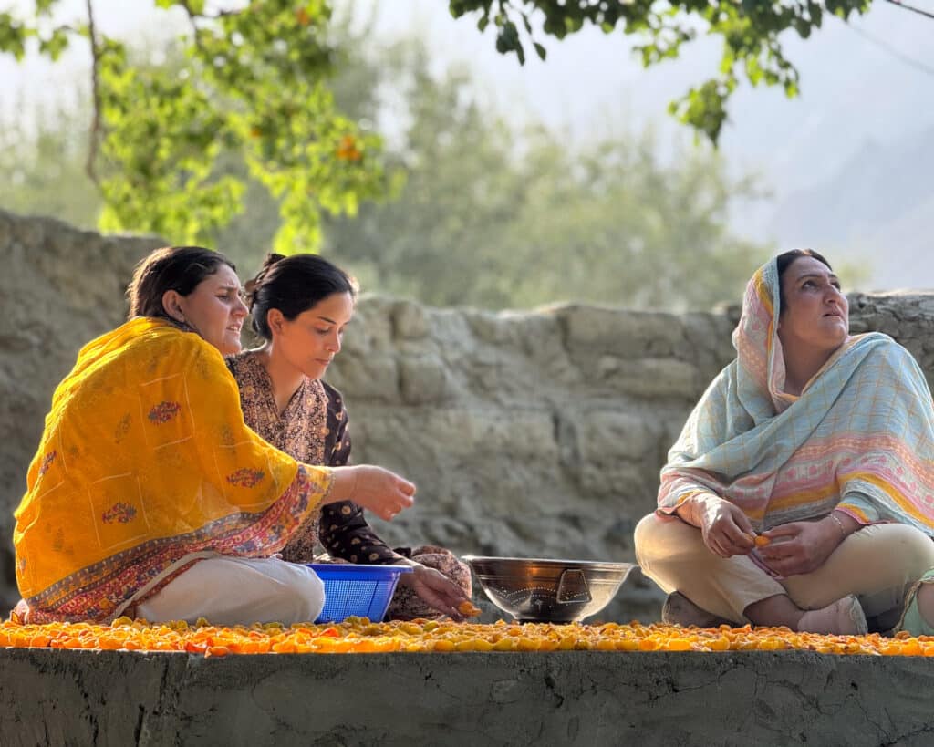 Cleaning apricots with Coyote Den Ishkoman staff