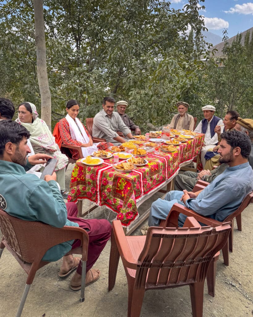 Alex sitting with a group of local men in Ishkoman