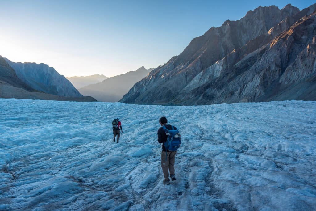 Crossing a glacier on the Pakora Pass trek from Naltar to Ishkoman Valley in Gilgit-Baltistan, Pakistan